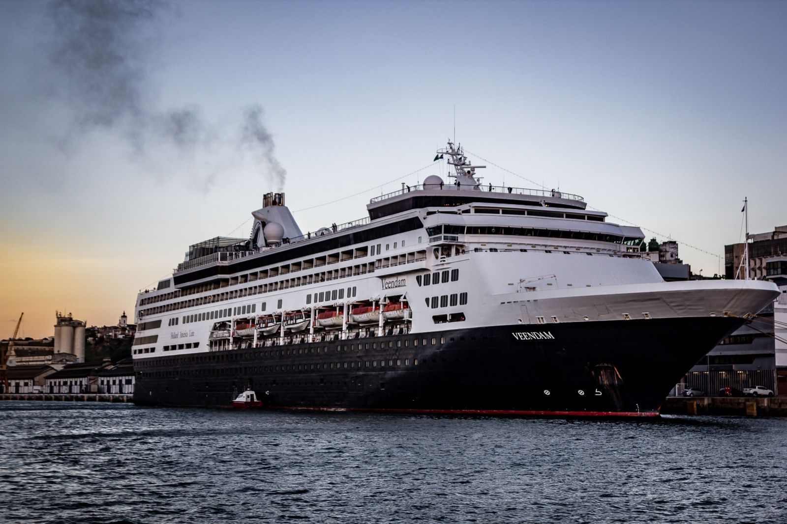 Cruise ship moored at a quay under a dramatic sky